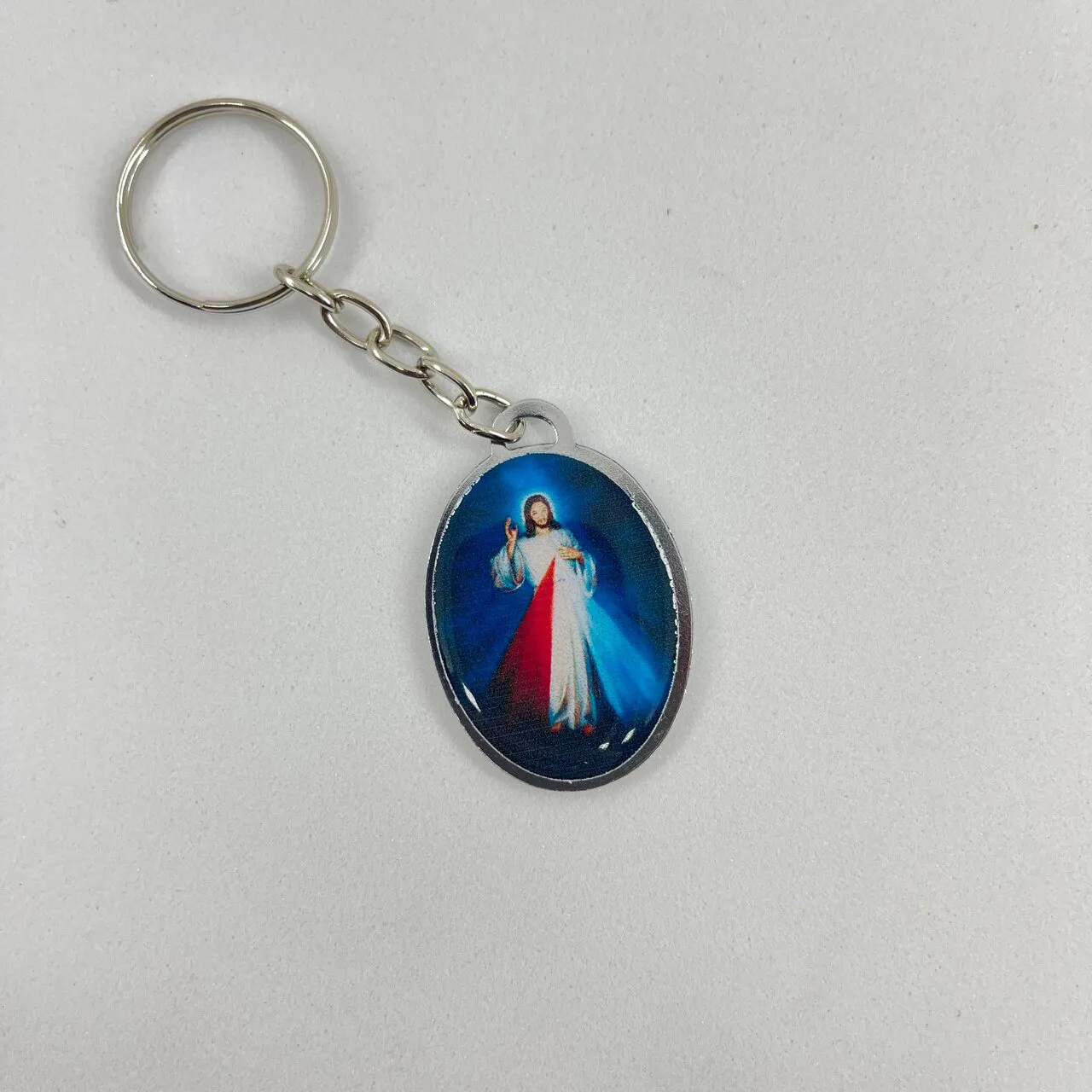 Chaveiro Oval Dupla Face Aparecida e Jesus Misericordioso
