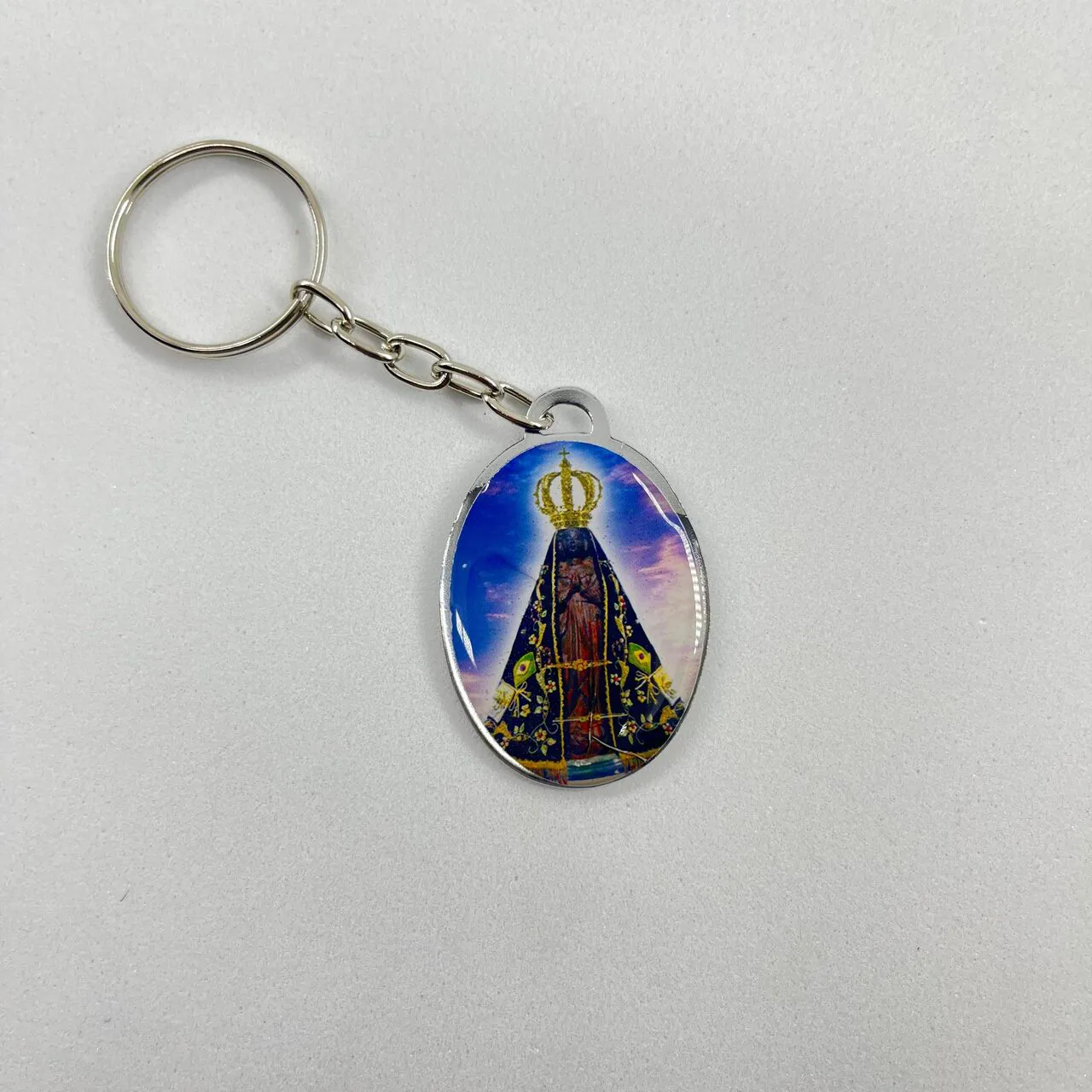 Chaveiro Oval Dupla Face Aparecida e São Jorge